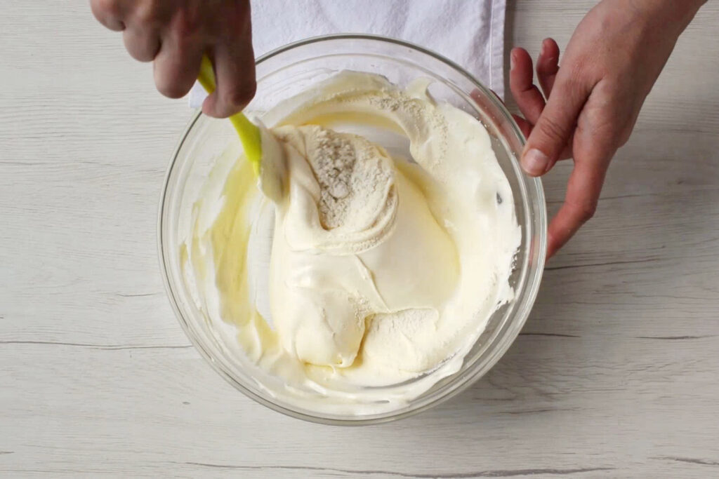 How to make homemade Ladyfingers: Gently fold the egg yolks into the meringue